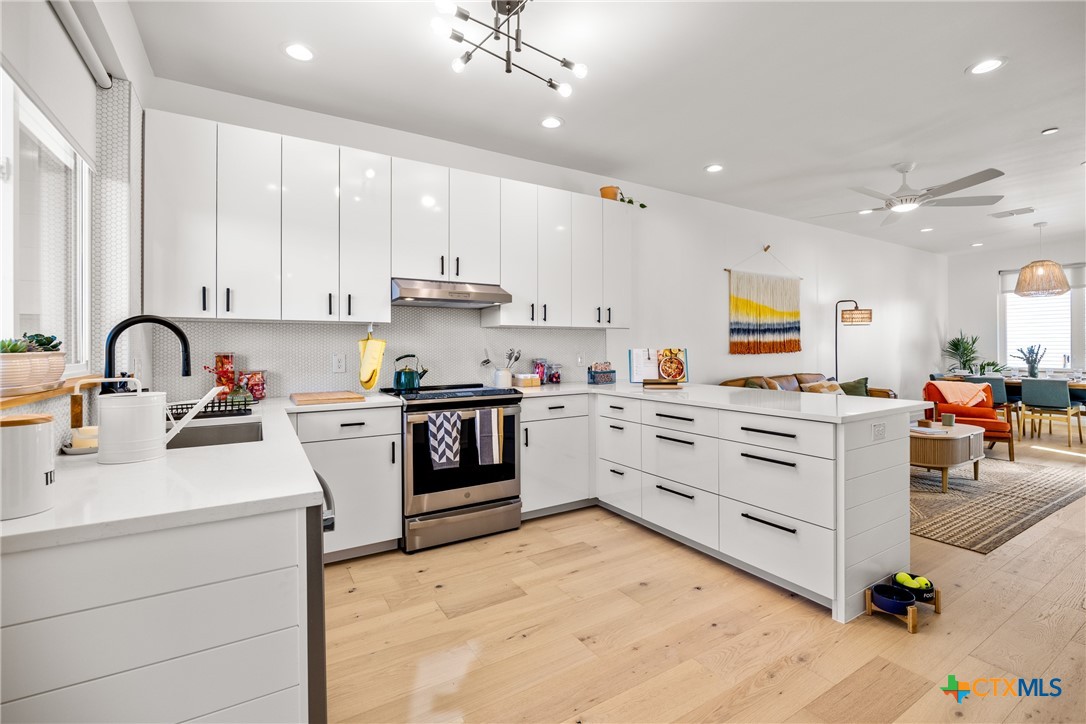 1909 Dutton Drive, Unit B San Marcos, TX 78666 - Photo 6 of 25 a kitchen with white cabinets appliances and a sink