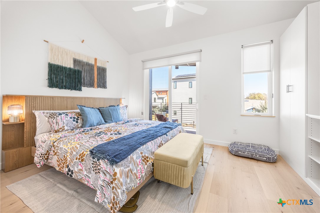 1909 Dutton Drive, Unit B San Marcos, TX 78666 - Photo 9 of 25 a bedroom with a bed and a night stand