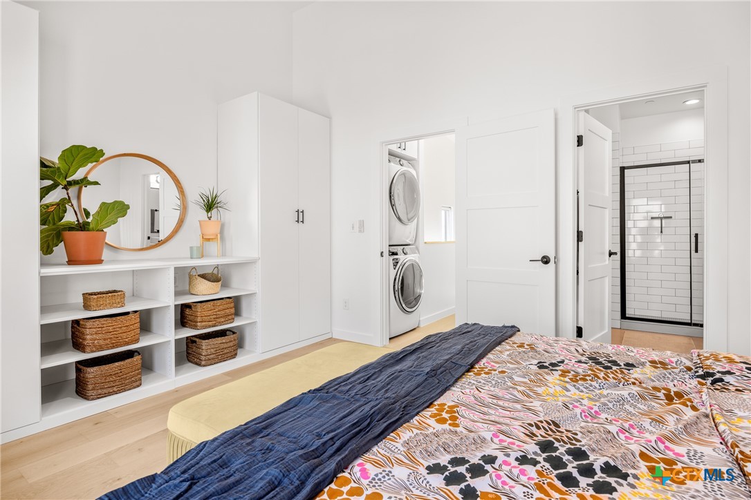 1909 Dutton Drive, Unit B San Marcos, TX 78666 - Photo 10 of 25 a bedroom with bed and wooden floor