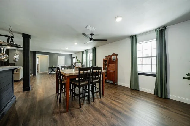 a view of a a dining room with furniture window and wooden floor