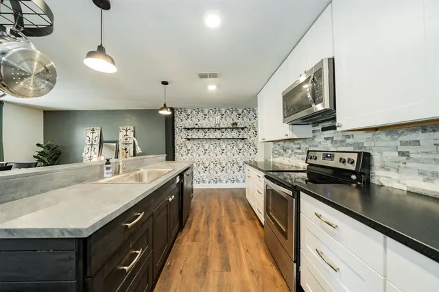 a large kitchen with a stove and a sink