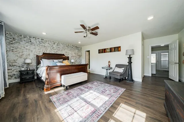 a bedroom with furniture and wooden floor