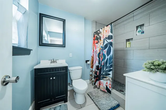 a bathroom with a toilet sink and mirror