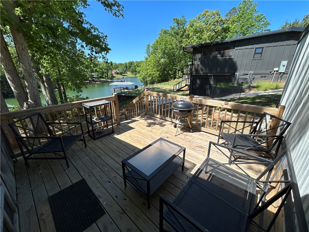 43 Sunset Cove Road Abbeville, SC 29620 - Photo 23 of 41 This spacious deck offers a tranquil retreat with breathtaking lake views, perfect for outdoor living.
