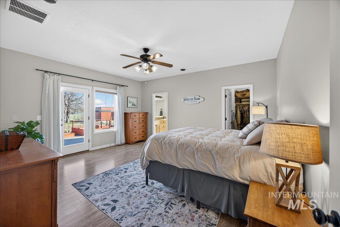 5408 Cassia Road New Plymouth, ID 83655 - Photo 14 of 49 Bedroom with wood finished floors, access to outside, a ceiling fan, and a walk in closet