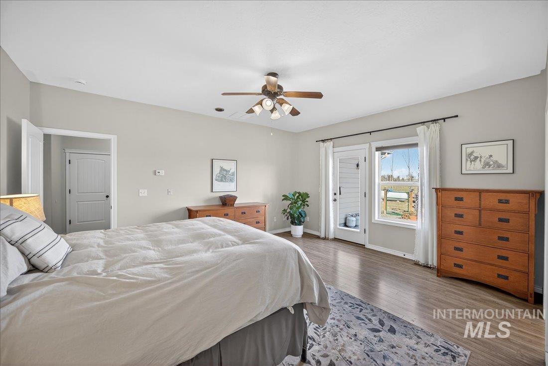 5408 Cassia Road New Plymouth, ID 83655 - Photo 15 of 49 Bedroom featuring access to outside, wood finished floors, and ceiling fan
