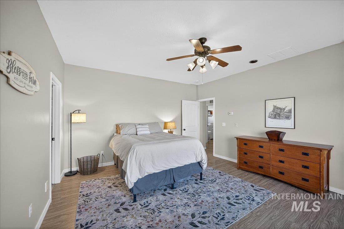 5408 Cassia Road New Plymouth, ID 83655 - Photo 16 of 49 Bedroom featuring a ceiling fan and wood finished floors