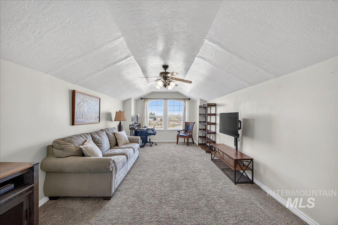 5408 Cassia Road New Plymouth, ID 83655 - Photo 22 of 49 Living room featuring a textured ceiling, carpet floors, and ceiling fan