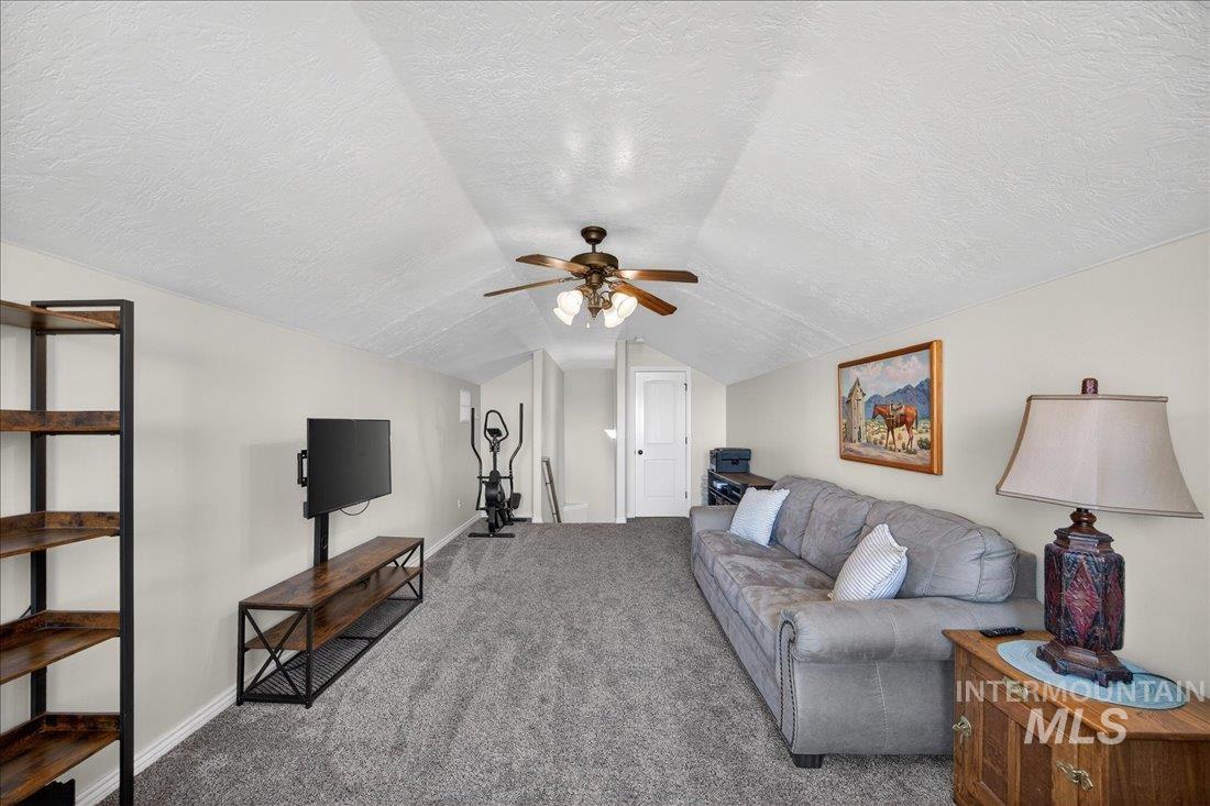 5408 Cassia Road New Plymouth, ID 83655 - Photo 23 of 49 Living area featuring a ceiling fan and carpet