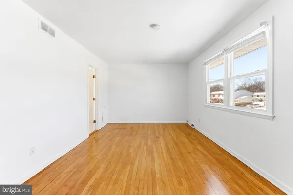 a view of a room with wooden floor and windows