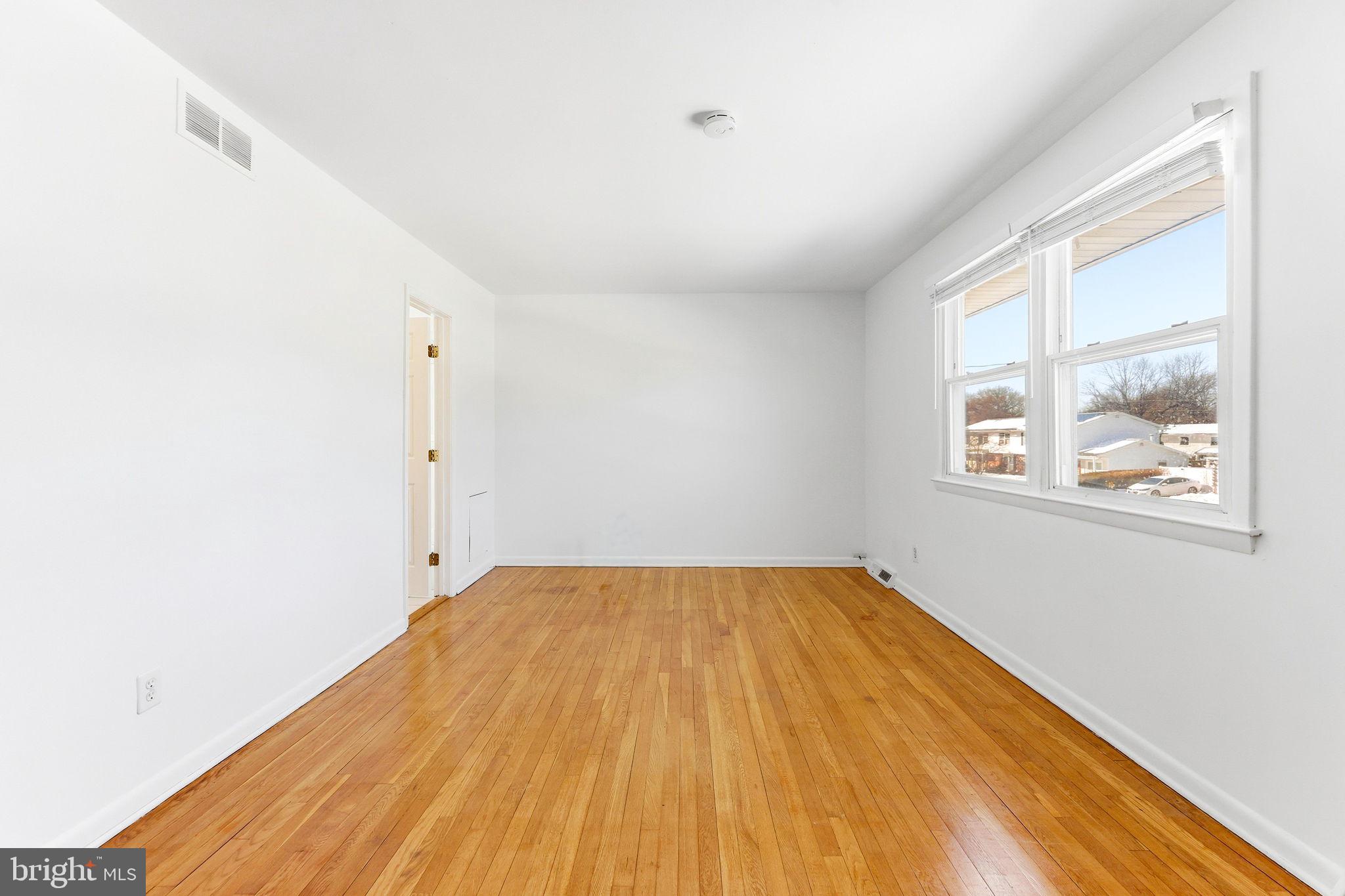 623 Chapelgate Drive Odenton, MD 21113 - Photo 11 of 24 a view of a room with wooden floor and windows
