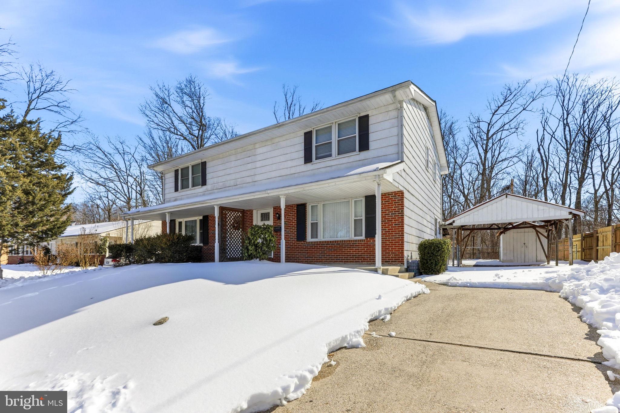 623 Chapelgate Drive Odenton, MD 21113 - Photo 2 of 24 a view of a white building with a large tree
