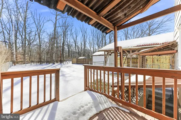 a view of a white house with a sink and wooden floor