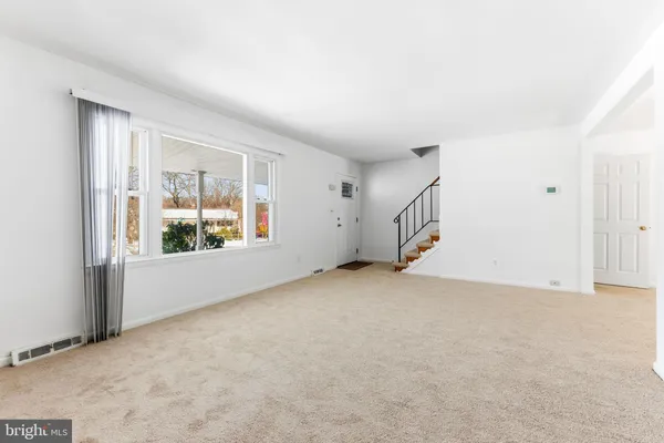 an empty room with windows & dryer