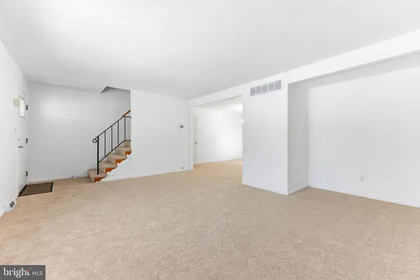 a view of an empty room with stairs