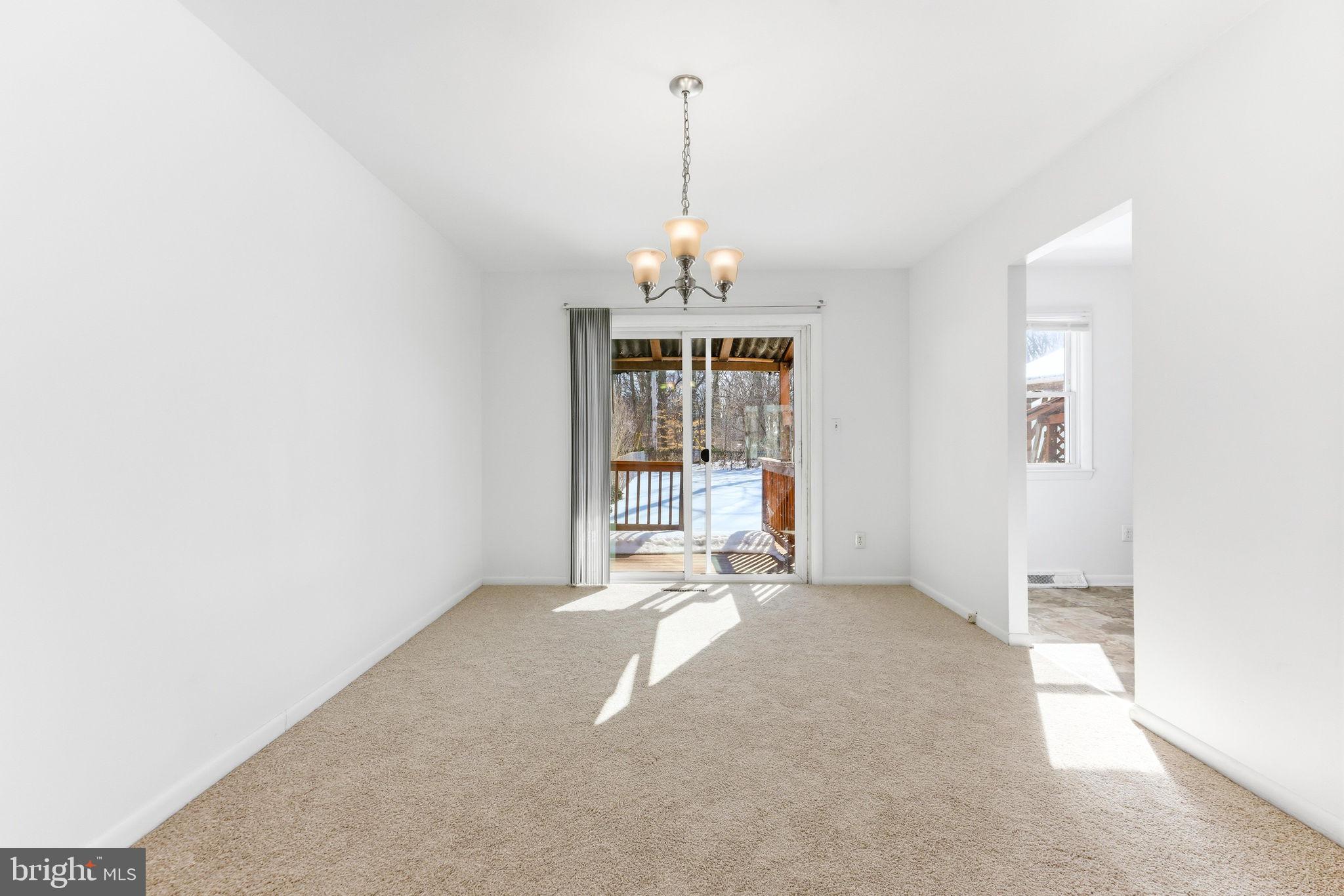 623 Chapelgate Drive Odenton, MD 21113 - Photo 5 of 24 an empty room with chandelier fan and windows