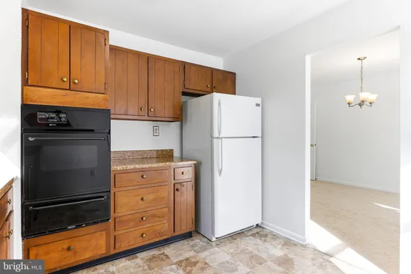 a kitchen with refrigerator cabinets and wooden floor