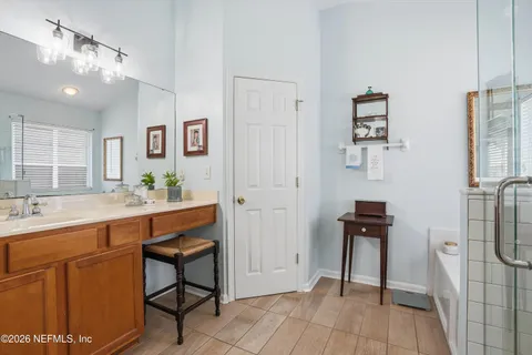 a spacious bathroom with a granite countertop sink a toilet a mirror and vanity