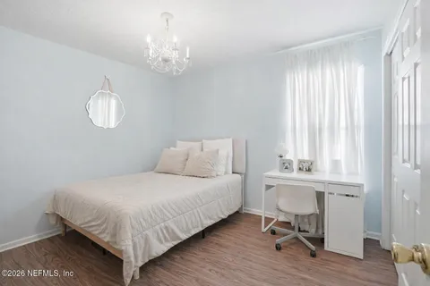 a bedroom with a bed and a table