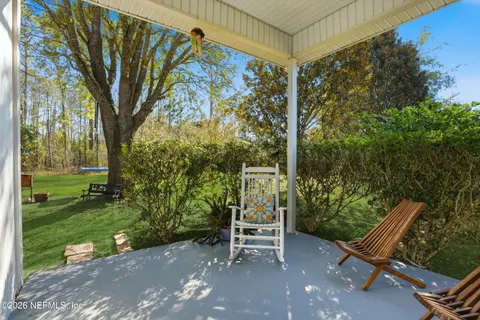 a view of a two chairs in the garden