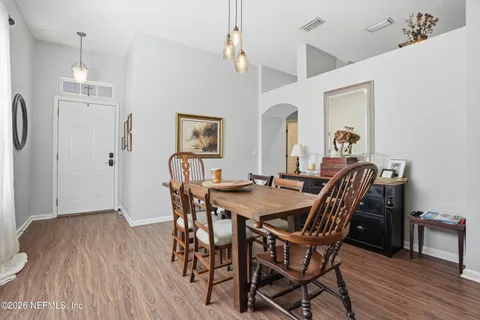 a view of a dining room with furniture and wooden floor