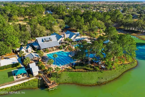 an aerial view of a house with a garden and swimming pool