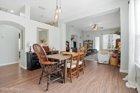 a view of a dining room with furniture and wooden floor