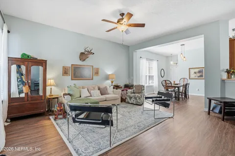 a living room with furniture and wooden floor