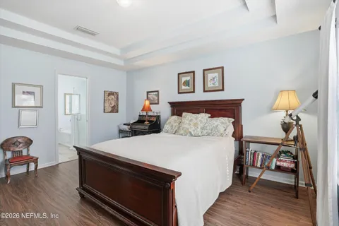 a bed room with a bed and a chair