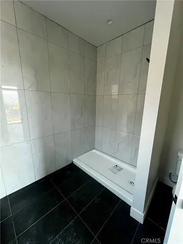 a bathroom with a glass shower door