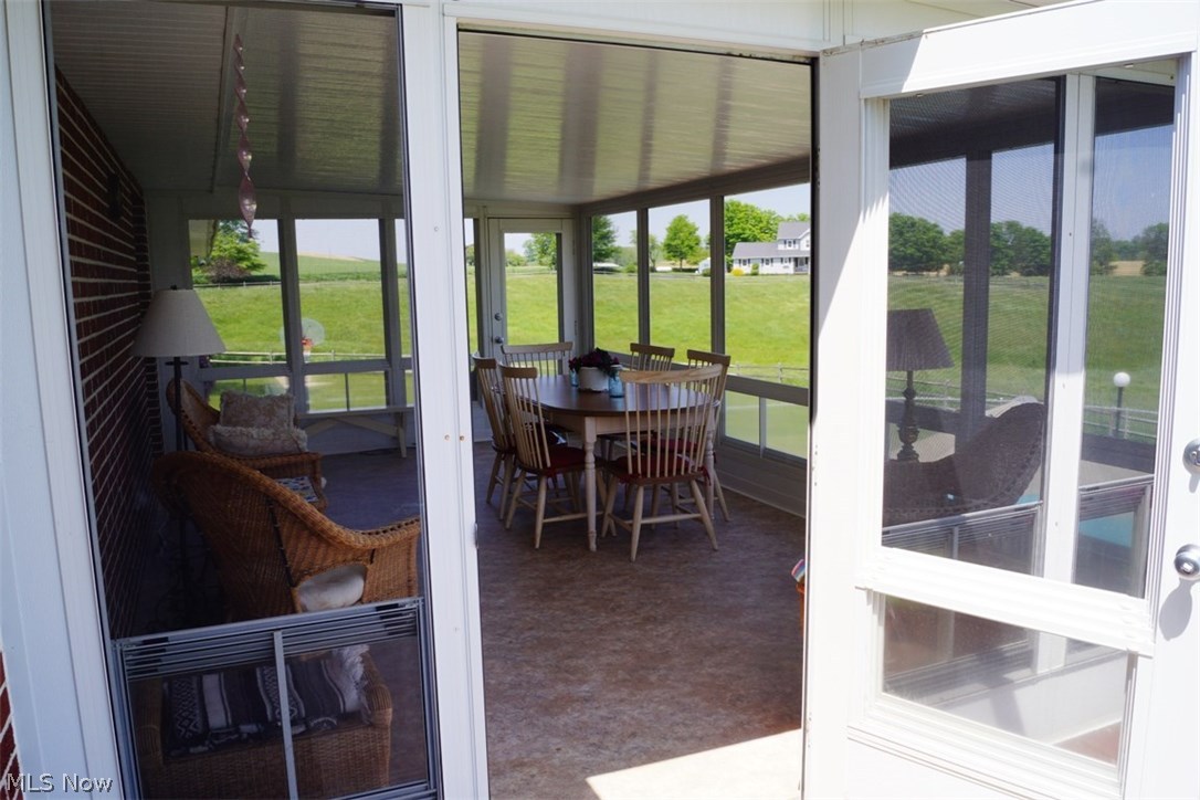 8472 Lowmiller Road Minerva, OH 44657 - Photo 17 of 35 WONDERFUL 3 SEASON SUN ROOM HAS SERVED MANY FAMILY GATHERINGS.