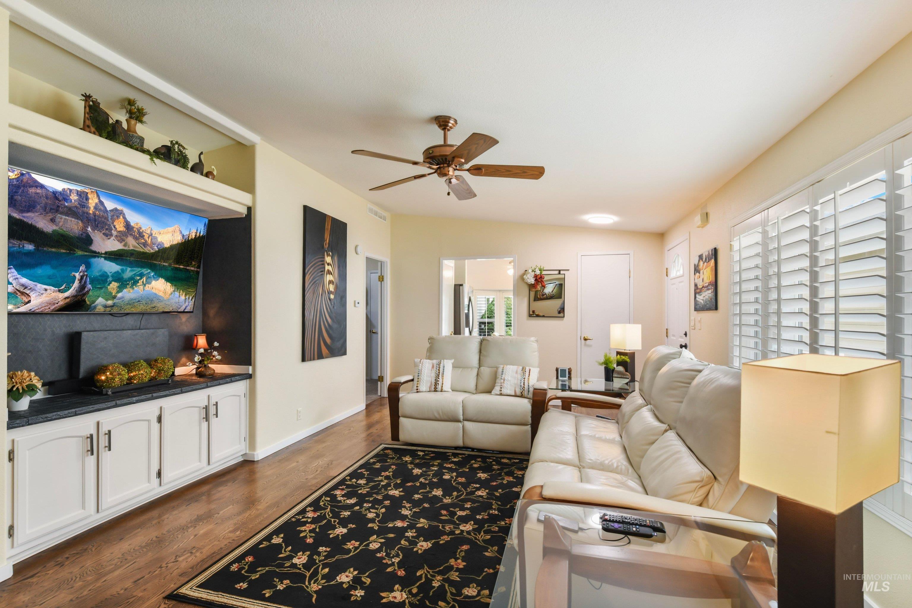 421 South Curtis Road, Unit 202 202 Boise, ID 83705 - Photo 8 of 41 Living area featuring wood-finish flooring, plantation shutters, and a ceiling fan