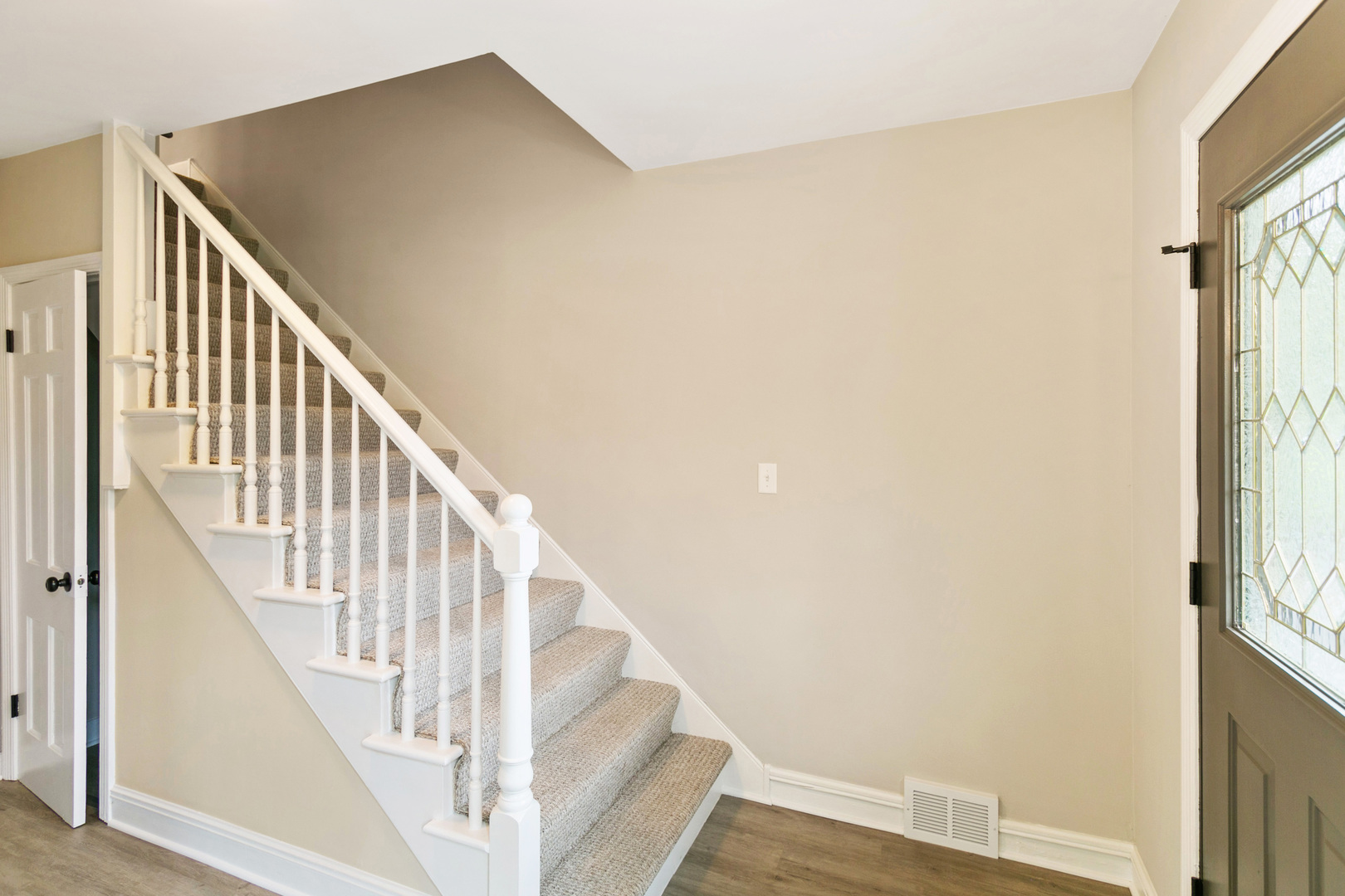 239 Cornwall Drive Crete, IL 60417 - Photo 6 of 25 a view of staircase with wooden floor and white walls
