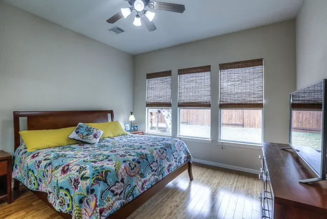 a bedroom with a large bed and a chandelier
