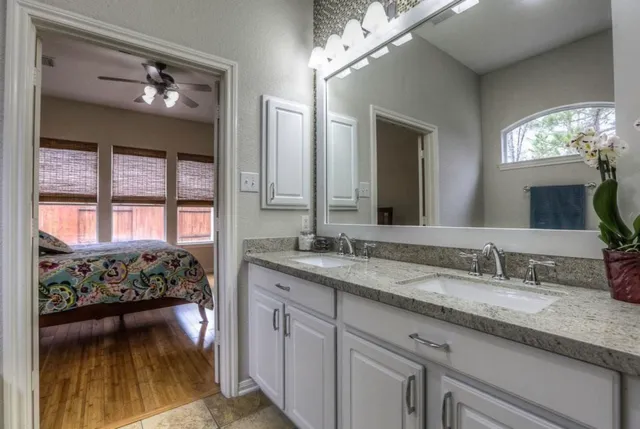 a en suite bathroom with a large mirror and sink