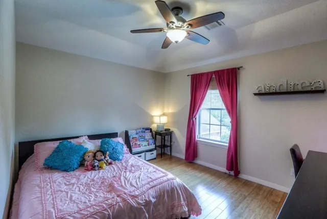 a bedroom with a bed and a window