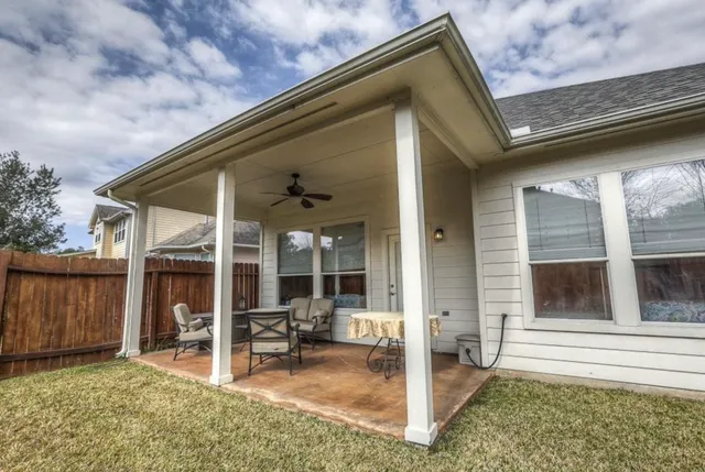 a backyard of a house with yard and outdoor seating