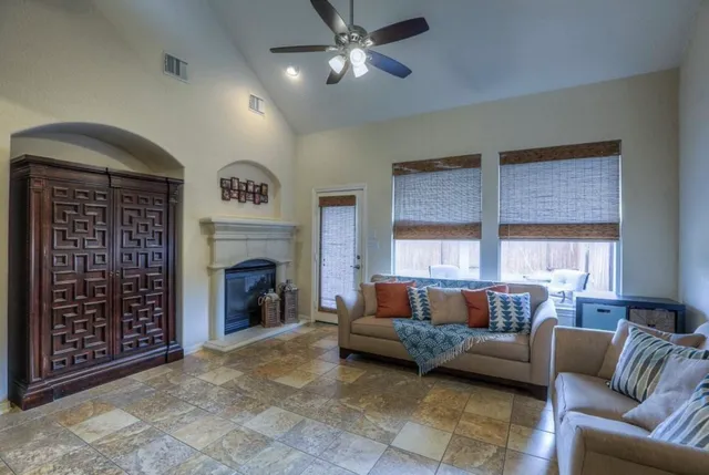 a living room with furniture and a fireplace