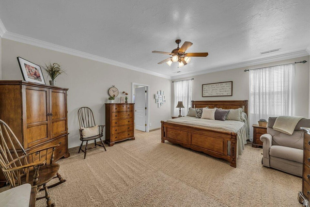 841 1010 S Street St. George, UT 84790 - Photo 12 of 33 Bedroom with ceiling fan, light colored carpet, and ornamental molding