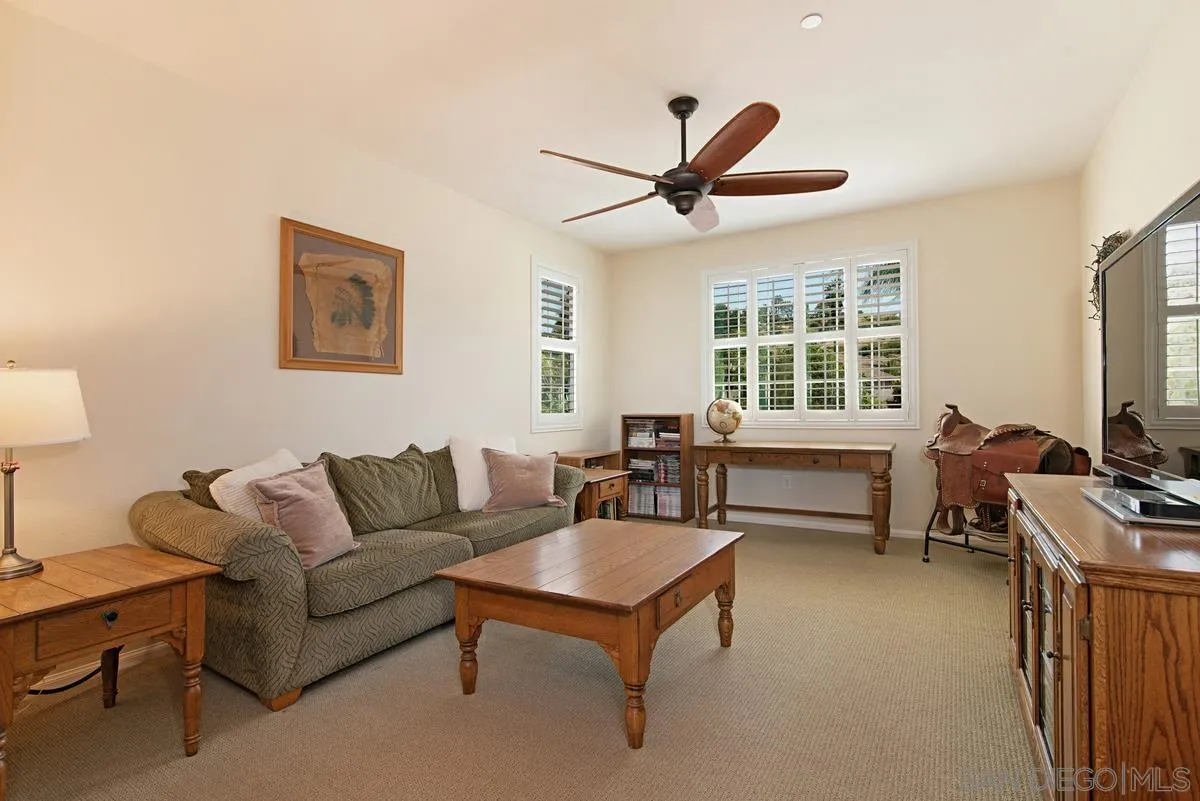 1121 Ocean Ridge Court Oceanside, CA 92056 - Photo 21 of 30 a living room with furniture a window and a flat screen tv