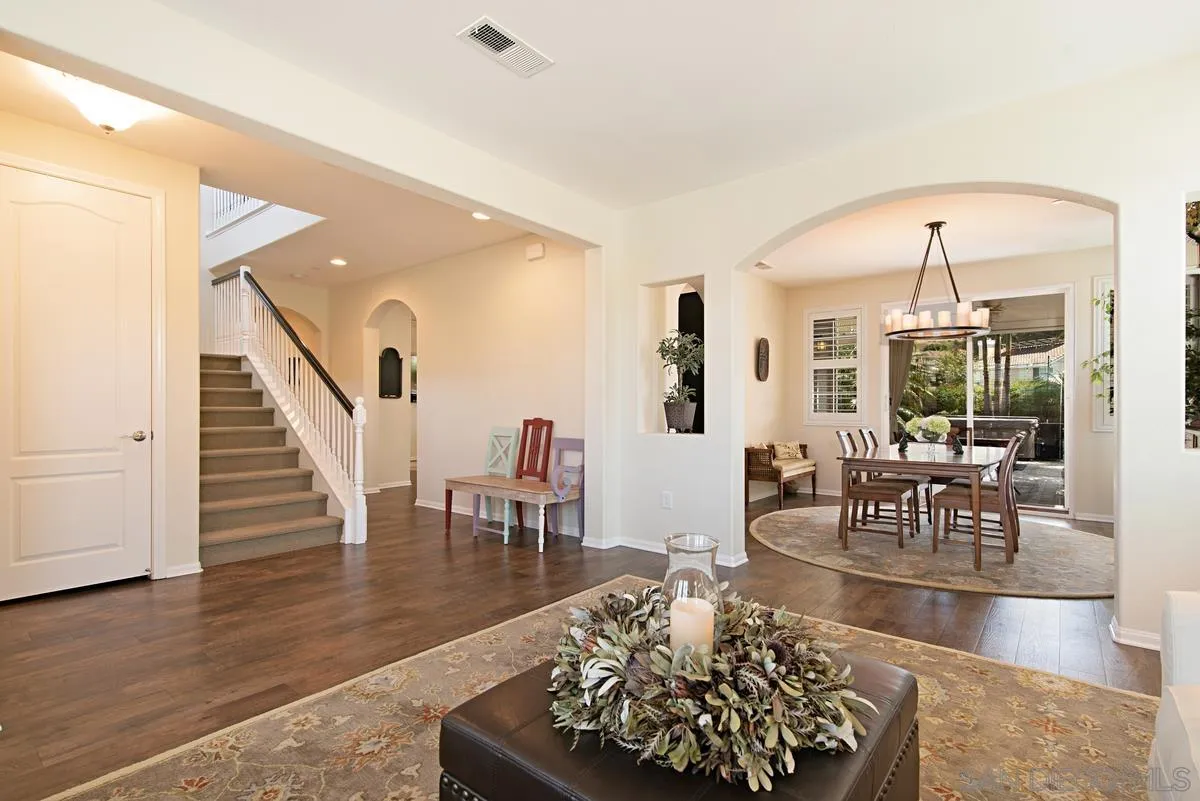 1121 Ocean Ridge Court Oceanside, CA 92056 - Photo 5 of 30 a living room with lots of furniture and a dining table with wooden floor