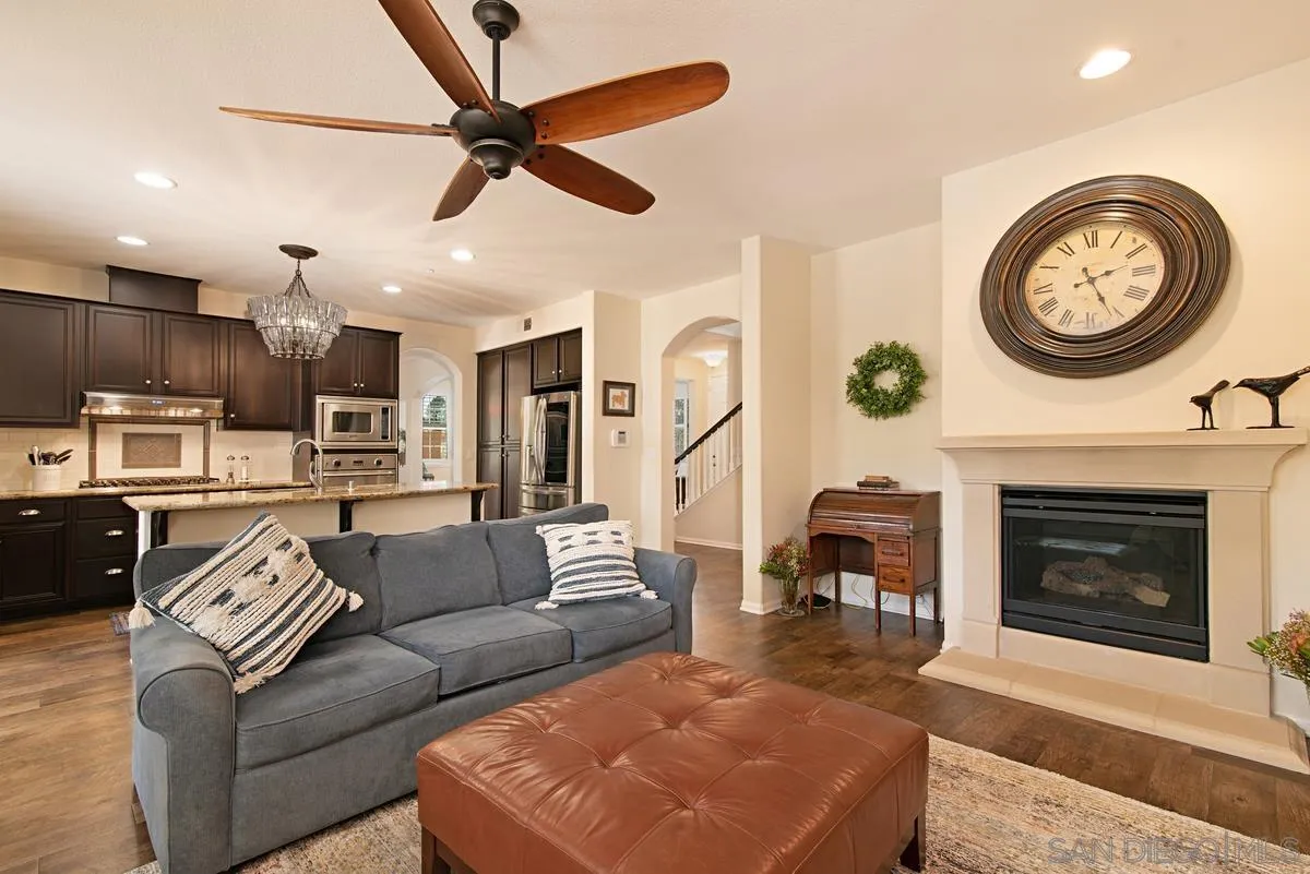 1121 Ocean Ridge Court Oceanside, CA 92056 - Photo 8 of 30 a living room with furniture a clock and a fireplace
