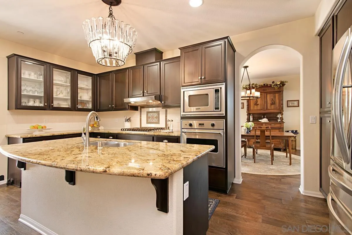1121 Ocean Ridge Court Oceanside, CA 92056 - Photo 10 of 30 a kitchen with stainless steel appliances granite countertop a sink refrigerator and cabinets