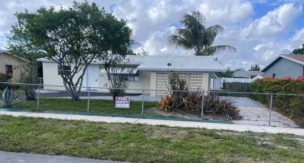 a view of house with patio and garden