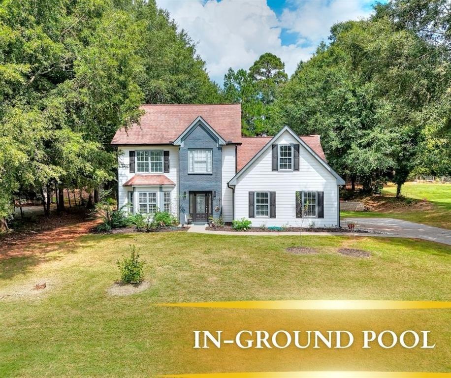 413 Spring Place Monroe, GA 30655 - Photo 1 of 1 a front view of a house with a garden