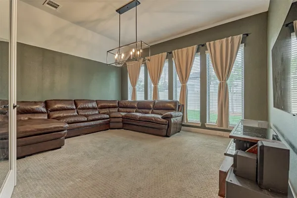 a living room with furniture and a chandelier