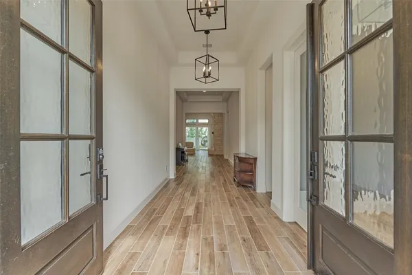 a view of a hallway view with wooden floor and staircase
