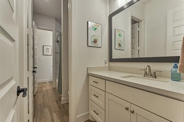 a bathroom with a granite countertop sink vanity mirror and