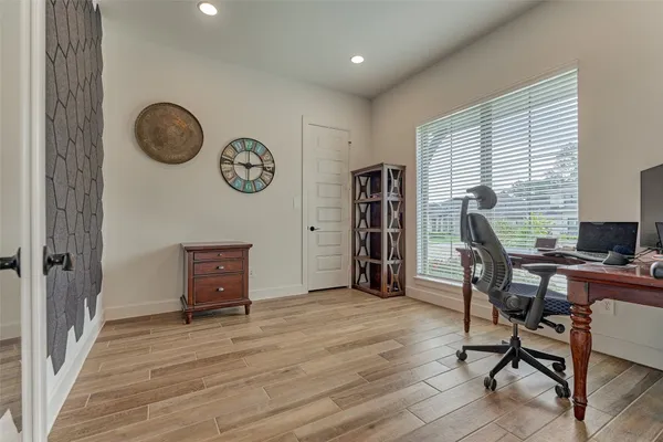 a view of a workspace with furniture and a window