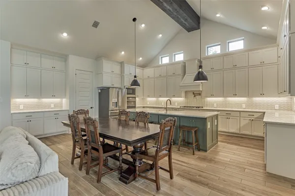 a kitchen with a table and chairs in it
